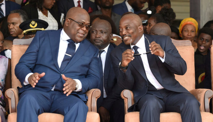 FILE PHOTO: Democratic Republic of Congo's outgoing President Joseph Kabila sits next to his successor Felix Tshisekedi during an inauguration ceremony in Kinshasa